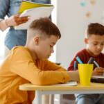 Two schoolchildren during a lesson and a test at school